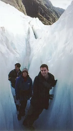 Man in warm clothes walking inside a glacier